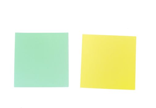 An image of yellow and green sticky notes on white