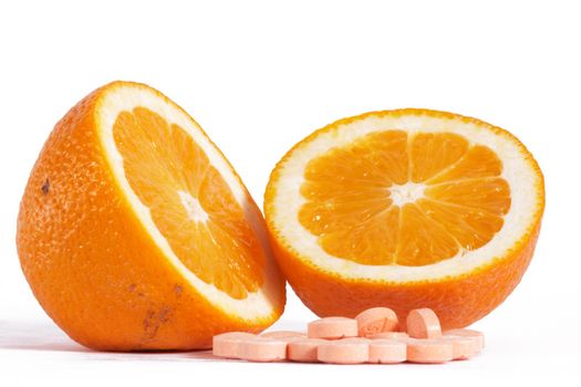 Pills of vitamins on a background of orange