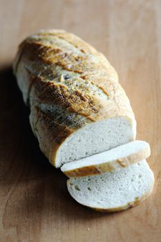 An image of a loaf of fresh white bread on the table