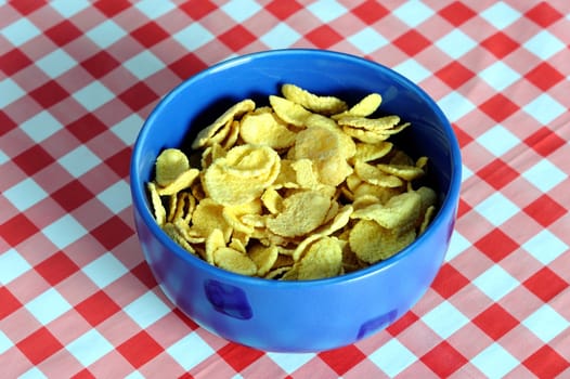 An images of cereal flakes in a blue bowl