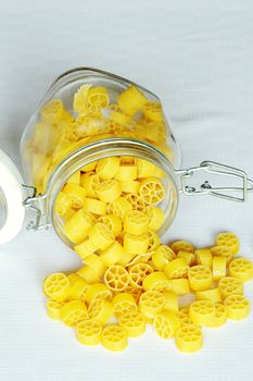 An image of bright yellow pasta in a jar