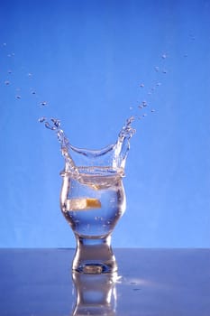 A glass with a drink splashing about
