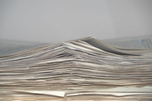 An image of a stock of old newspapers