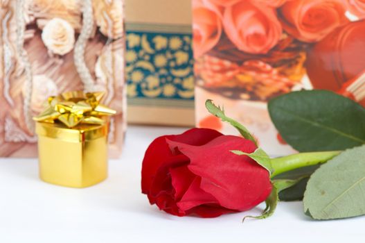 An image of jewelry in box and rose