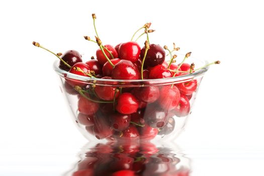 An image of red berries in a glass close up