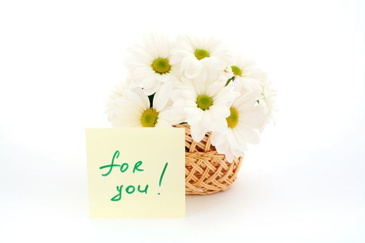An image of basket with white daisies with inscription (for you)