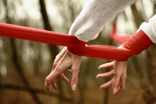 An image of hands bonded with red stripe