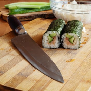 An image of a rolls and knife close-up