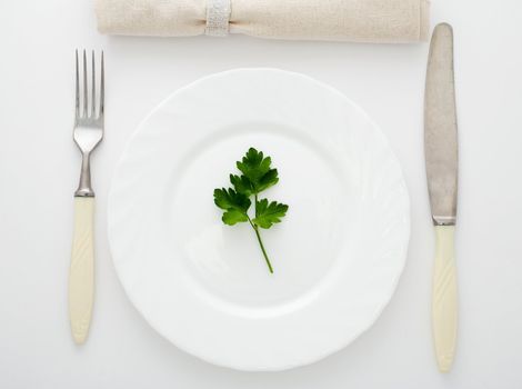 An image of fork, knife and plate on the table