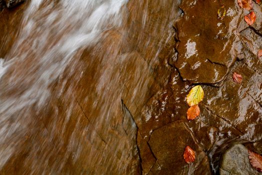 An image of falling river in autumn mountains
