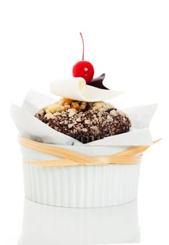 Chocolate muffin with white and dark chocolate and cherry on the top on white  background