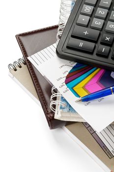 Arrangement of office supply, calculator and blocks closeup isolated on white background