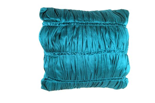 A small pillow with a shiny turquoise cover, on white studio background.