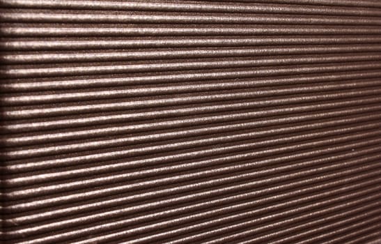 A background of a pattern of diagonal lines on a shiny surface.