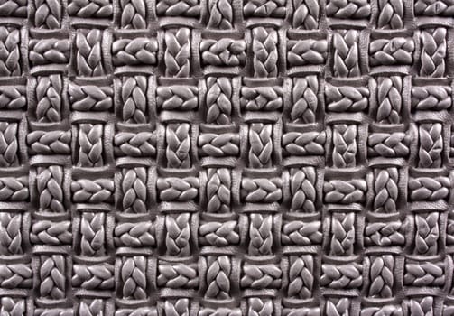 A background of a closeup view of a woven artistic pattern /design on a fabric.