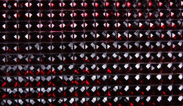 A background with a horizontal pattern of crimson and red gemstones.
