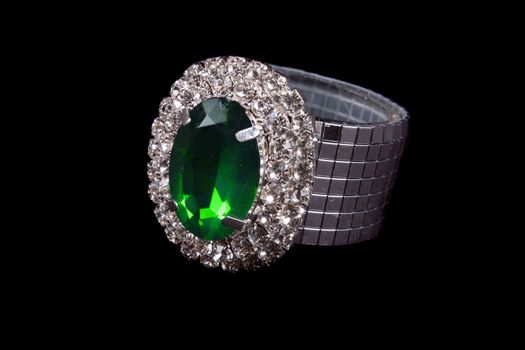 A beautiful ring studded with diamonds and a green jewel.