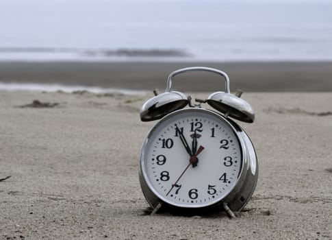 clock on the beach with time five for twelfe