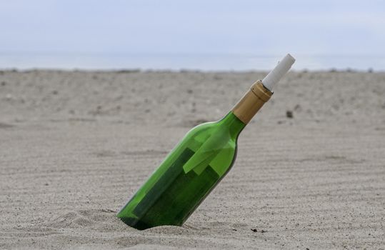 message in a green bottle on the beach