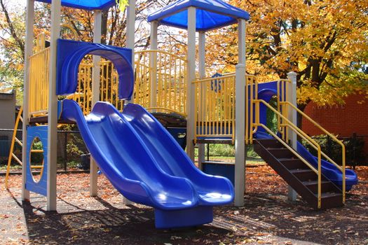 childrens school playground with slide and climbing bars