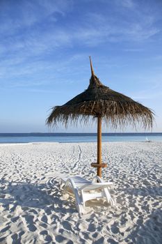 Straw parasol providing shade on the beach