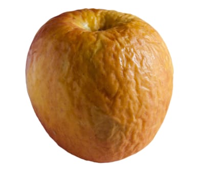 Macro shot of an old wrinkled yellow apple against white background