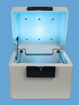 Fire proof safe open and isolated against blue with lid open
