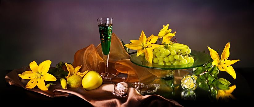 Still life with yellow lily and fresh fruits 