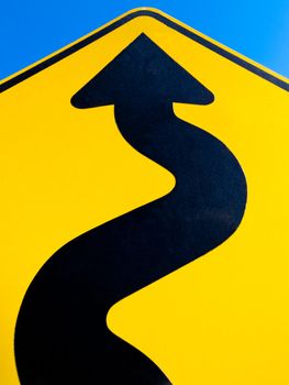 Wavy arrow on road sign pointing upward in a concept of achievement, advancement and success