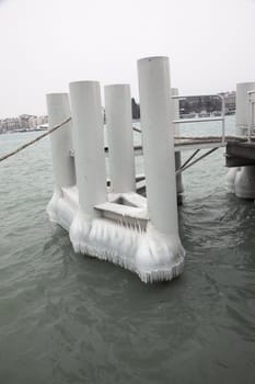 Pontoon on the lake covered by ice due to extremem winter weather.