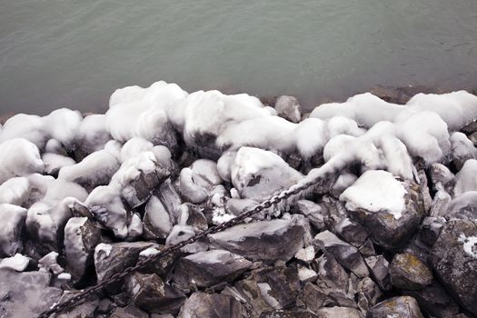 Heavy winter weather deposits ice on rocks