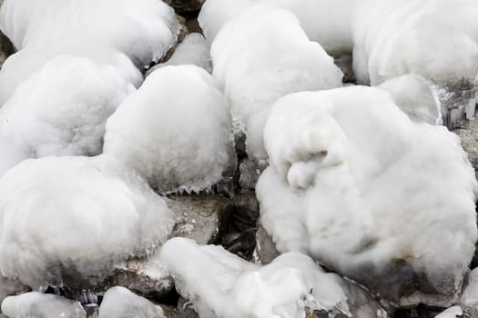 Heavy winter weather deposits ice on rocks