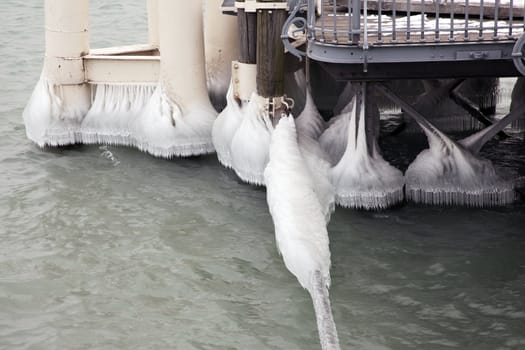 Heavy winter weather deposits ice on moorings in the water