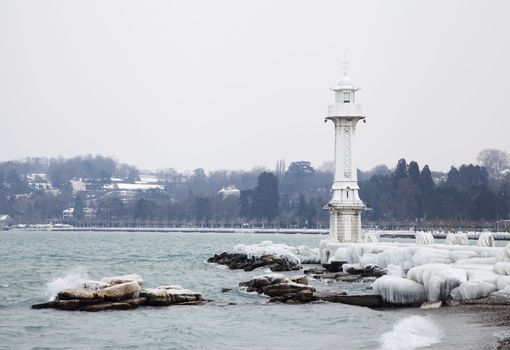 Lighthouse on Lake Geneva and its surroundings are covered by a thick layer of ice caused by extreme winter weather







Frozen Geneva lighthous