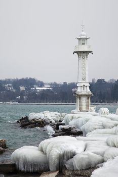 Lighthouse in Geneva is covered by ice during winter
