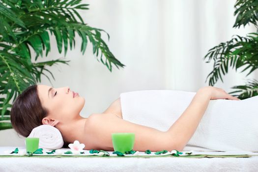 Attractive brunette woman resting after massage