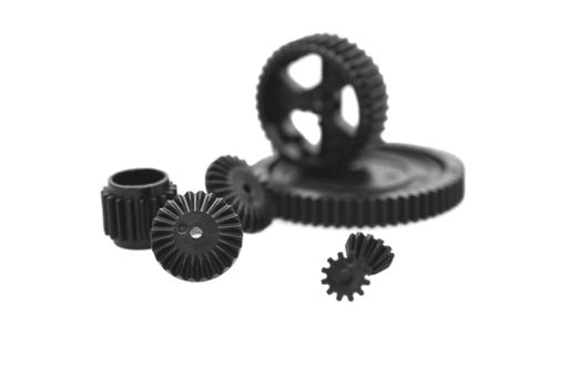 Black metal gear wheels of the different size on a white background