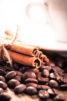 Coffee beans and cinnamon sticks closeup