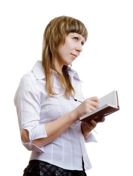 young girl in a white blouse writes in a notebook