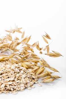 Oat flakes heap isolated on white background