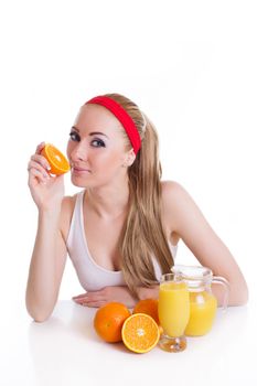 Sporty woman sitting with orange juice and fruits