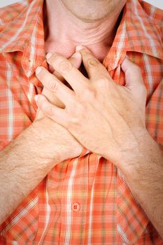 Both man's hands on breast because of hard breathing 
