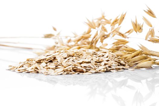 Oat flakes heap isolated on white background