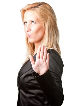Blond businesswoman shows palm of the hand meaning she's not listening to what's being said