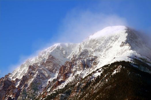 Intense winds create a fog of snow over Mount Chapin of Rocky Mountain National Park in Colorado.