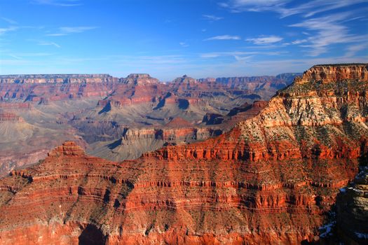 Jagged rocky mountains rise steepy from the floor of the Grand Canyon in Arizona.
