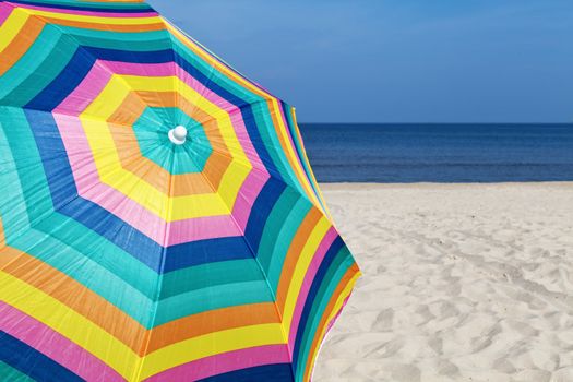 Umbrella on a sandy beach, summer time
