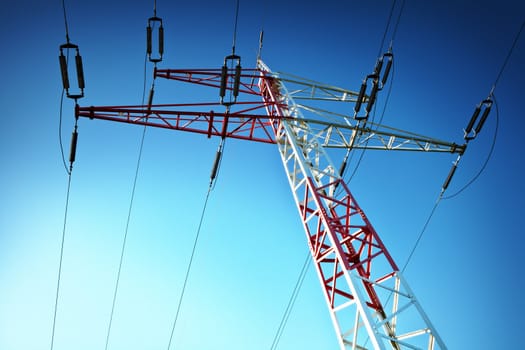 Electric high voltage pylon against blue sky