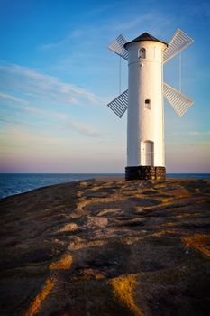 White old lighthouse in Swinoujscie at sunrise, Poland