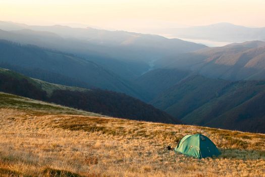 An image of tent in the mountains